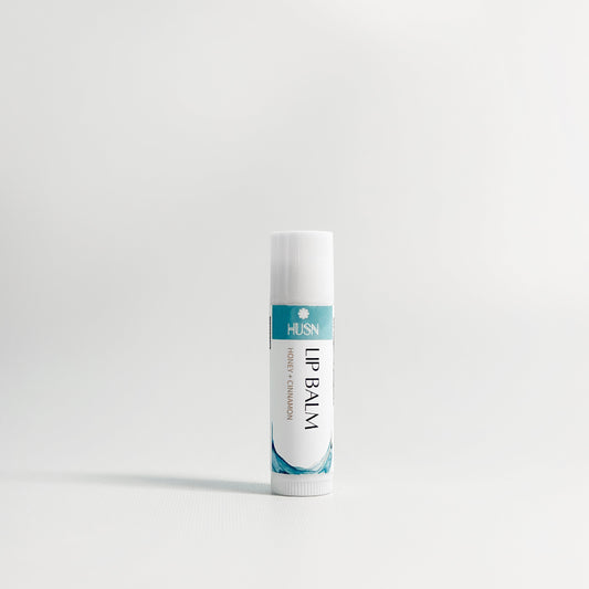 Lip balm tube with visible brand name on a white background